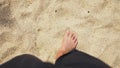 Men`s Legs on the sea sand and wave, Relaxation on the ocean beach, Summer holidays.