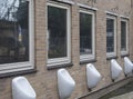 A Men`s public pissoirs mounted on a wall in 'Mediamatic' cultural centre of Amsterdam,