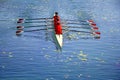 Men`s quadruple rowing team on blue water