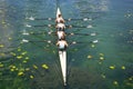 Mens quadruple rowing team on turquoise green lake