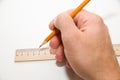 Men's right hand holding a pencil on over white