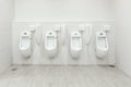 Men`s room urinals discharge of waste from the body Royalty Free Stock Photo