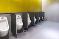 Men`s room urinals discharge of waste from the body Royalty Free Stock Photo