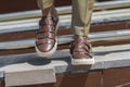 Men`s sandals on the leg are close-up brown Royalty Free Stock Photo