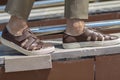 Men`s sandals on the leg are close-up brown with shortened trousers Royalty Free Stock Photo