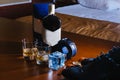 Men`s shoes, a belt rolled up by a ring, watches, cologne, a bottle of alcohol, two glasses with alcohol and an Royalty Free Stock Photo