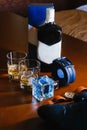 Men`s shoes, a belt rolled up by a ring, watches, cologne, a bottle of alcohol, two glasses with alcohol and an Royalty Free Stock Photo