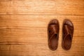 Men`s shoes on the boards. Slippers close-up. Men`s brown sneakers. Summer shoes Royalty Free Stock Photo