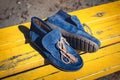 men& x27;s shoes moccasins blue color. photo on the street, yellow bench
