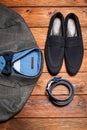 Men's suit, belt and footwear on a wooden background Royalty Free Stock Photo