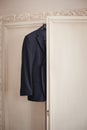 Men`s suit hanging on trempel