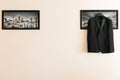 The men`s suit hangs in the picture on the right. there is space for text. Businessman`s morning