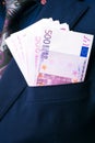 In Men's Suits 500 euro. Bribe and corruption with euro banknotes.