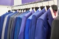 Men`s suits with shirts in clothing store Royalty Free Stock Photo
