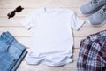 MenÃ¢â¬â¢s T-shirt mockup with gray running shoes, sunglasses Royalty Free Stock Photo