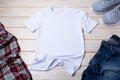 MenÃ¢â¬â¢s T-shirt mockup with indigo jeans and gray running shoes Royalty Free Stock Photo