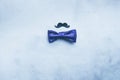 Men`s tie butterfly black mustache photo props on a blue fashionable background. Concept of male holiday Flat layout