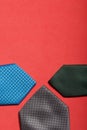 Men`s ties in different colors and sizes. For father and sons. Love and Togetherness Objects. On a coral background Royalty Free Stock Photo