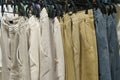 Men's trousers hang on hangers in a clothing store. Royalty Free Stock Photo