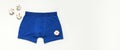 Men`s underwear, blue underpants and cotton flowers on white background flat lay top view copy space. Fashion blog, natural Royalty Free Stock Photo