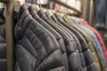 Men`s warm autumn and winter jackets down jackets neatly hang in a row in a clothing store on a hanger Royalty Free Stock Photo