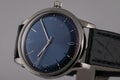 Men`s watch with black leather strap,blue dial, in silver body,gray clockwise and numerals isolated on gray background.