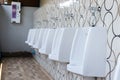 Men`s white urinals design, Close up row of outdoor urinals men public toilet Royalty Free Stock Photo