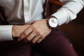 Men`s wrist watch, the man is watching the time. Businessman clock, businessman checking time on his wristwatch. Groom`s Royalty Free Stock Photo