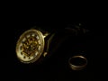Men`s wristwatch and a ring on a black velvet.