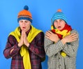 Men with sad faces on blue background. Siblings are cold Royalty Free Stock Photo