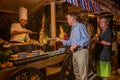 Men selecting food during the international cuisine dinner outdoors setup at the tropical island restaurant
