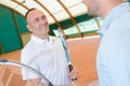 Men shaking hands over tennis court net Royalty Free Stock Photo