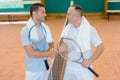 Men shaking hands over tennis court net Royalty Free Stock Photo