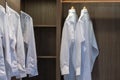 Men shirt hang in a wooden closet interior decoration Royalty Free Stock Photo