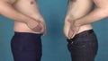 Men show off their bellies and make fun of abdomens. Overweight guys touches and shakes their bellies. Obesity