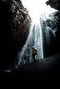 Men si standing near the waterfalls, stunnig view on the powerful water, Iceland