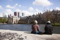 Men sit and look at mauritshuis and binnenhof in the hague