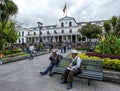 Men sit on a park bench in Independence Square in Quito in Ecuador. Royalty Free Stock Photo