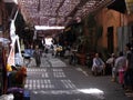 Men sitting in the doorway of a tea shop on a street in the souk of Marrakech. Morocco