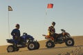 Men Sitting On Quad Bikes In Desert Royalty Free Stock Photo