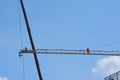Men sky high on a crane.
