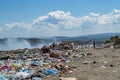 Men sorting garbage for recycling in a dumping ground of food and plastic wastes on summer heat Royalty Free Stock Photo