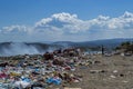 Men sorting garbage for recycling in a dumping ground of food and plastic wastes on summer heat Royalty Free Stock Photo