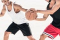 Men in sportswear playing basketball together Royalty Free Stock Photo