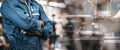 Men is standing with arms folded in a storage facility or warehouse Royalty Free Stock Photo