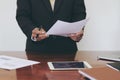 Men standing at desk and reading document hand close up.