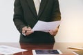 Men standing at desk and reading document hand close up.