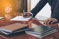 Men standing at desk and working writing document hand close up.