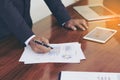 Men standing at desk and working writing document hand close up.