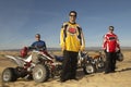 Men Standing By Quad Bikes In Desert Royalty Free Stock Photo